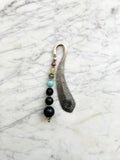 Silver feather bookmark with Indian Agate, Amazonite, Citrine and Rhodochrosite beads on a marble background