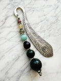 Silver feather bookmark with Indian Agate, Amazonite, Citrine and Rhodochrosite beads on a marble background