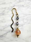 Decorative bookmark with glass beads on a marble surface