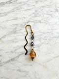 Decorative bookmark with glass beads on a marble surface