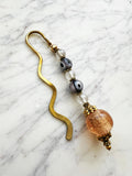 Decorative bookmark with glass beads on a marble surface