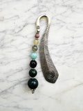 Silver feather bookmark with Indian Agate, Amazonite, Citrine and Rhodochrosite beads on a marble background