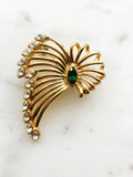 Vintage Gold-Plated Crystal Spray Brooch with Emerald Marquis Center on a marble background