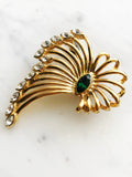 Vintage Gold-Plated Crystal Spray Brooch with Emerald Marquis Center on a marble background