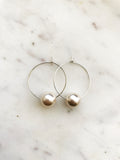 Make a stunning statement with these Vintage Glass Pearl Hoops! These unique and beautiful earrings feature vintage glass pearls, with a subtle shimmer to add a touch of glamour to any look. Handcrafted from broken vintage pearl necklace. Perfect for special occasions or everyday wear. You'll be a vision in these exquisite earrings!  30mm Silver Plated Hoops  10mm Vintage Glass Pearl