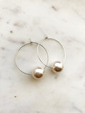 Make a stunning statement with these Vintage Glass Pearl Hoops! These unique and beautiful earrings feature vintage glass pearls, with a subtle shimmer to add a touch of glamour to any look. Handcrafted from broken vintage pearl necklace. Perfect for special occasions or everyday wear. You'll be a vision in these exquisite earrings!  30mm Silver Plated Hoops  10mm Vintage Glass Pearl