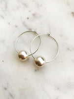 Make a stunning statement with these Vintage Glass Pearl Hoops! These unique and beautiful earrings feature vintage glass pearls, with a subtle shimmer to add a touch of glamour to any look. Handcrafted from broken vintage pearl necklace. Perfect for special occasions or everyday wear. You'll be a vision in these exquisite earrings!  30mm Silver Plated Hoops  10mm Vintage Glass Pearl