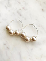 Make a stunning statement with these Vintage Glass Pearl Hoops! These unique and beautiful earrings feature vintage glass pearls, with a subtle shimmer to add a touch of glamour to any look. Handcrafted from broken vintage pearl necklace. Perfect for special occasions or everyday wear. You'll be a vision in these exquisite earrings!  30mm Silver Plated Hoops  10mm Vintage Glass Pearl