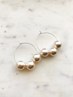 Make a stunning statement with these Vintage Glass Pearl Hoops! These unique and beautiful earrings feature vintage glass pearls, with a subtle shimmer to add a touch of glamour to any look. Handcrafted from broken vintage pearl necklace. Perfect for special occasions or everyday wear. You'll be a vision in these exquisite earrings!  30mm Silver Plated Hoops  10mm Vintage Glass Pearl