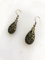 Make a fashion statement with these Antique Bronze Filigree Earrings! The intricate details will add charm and character to any look. Plus, the lightweight design ensures you won’t be weighed down by your baubles! Make like a jewelry box maestro and rock these earrings!  40mm drop from top of ear hook x 12mm