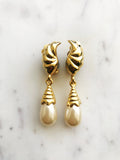 These vintage pearl drop clip on earrings add a little bit of nostalgia to your look! With a timeless design reminiscent of a classic style, these earrings are sure to be a hit with anyone who appreciates a bit of vintage glamour. Dazzle your friends and transport yourself back to a time of art deco elegance!  Gold Plated  Clip On   55mm x 11mm