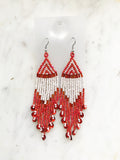 Add a touch of global flair to your look with this stunning pair of vintage tribal earrings. Crafted with vivid red seed beads, they bring an exotic charm to any outfit and are sure to make you stand out from the crowd! Who knew looking this good could be so easy?! Nickel free ear hooks for sensitive ears  Very light weight earrings  120mm x 28mm 