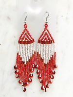 Add a touch of global flair to your look with this stunning pair of vintage tribal earrings. Crafted with vivid red seed beads, they bring an exotic charm to any outfit and are sure to make you stand out from the crowd! Who knew looking this good could be so easy?! Nickel free ear hooks for sensitive ears  Very light weight earrings  120mm x 28mm 