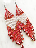 Add a touch of global flair to your look with this stunning pair of vintage tribal earrings. Crafted with vivid red seed beads, they bring an exotic charm to any outfit and are sure to make you stand out from the crowd! Who knew looking this good could be so easy?! Nickel free ear hooks for sensitive ears  Very light weight earrings  120mm x 28mm 