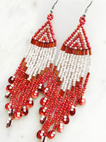 Add a touch of global flair to your look with this stunning pair of vintage tribal earrings. Crafted with vivid red seed beads, they bring an exotic charm to any outfit and are sure to make you stand out from the crowd! Who knew looking this good could be so easy?! Nickel free ear hooks for sensitive ears  Very light weight earrings  120mm x 28mm 