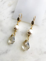 These earrings are a delightful fusion of vintage nostalgia and contemporary chic! Crafted from a once-broken strand of timeless glass pearls and paired with discontinued crystals, they carry the charm of yesteryears with a modern twist. Perfect for any occasion. Embrace the allure of bygone eras with a touch of whimsy – because true style knows no bounds!  Discontinued Crystal 6680 Cosmic Pendant 20mm Crystal (001) Silver Shade (SSHA)  Vintage Glass Pearl 10mm  Gold Plated