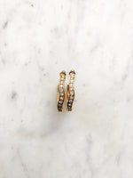 Jazz up your look with these playful Vintage Gold Crystal Hoops! These quirky hoops feature shimmering crystals that will add a touch of glam to any outfit. Step up your earring game and make a statement with these unique hoops.  Gold Plated Hoops  33mm x 33mm  Surgical Steel Posts for Sensitive Ears