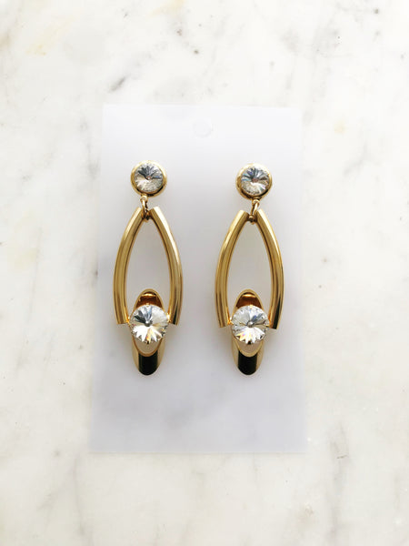 Add a touch of retro glamour to any outfit with these sparkling Crystal Earrings. A timeless design featuring shimmering crystals that will elevate your style to the next level. These earrings are the perfect accessory for any occasion and a must-have for any fashion-forward individual.  62mm x 26mm