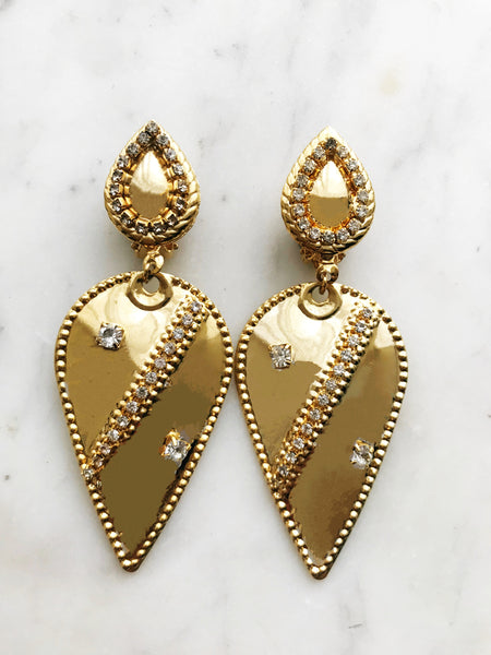 Add a touch of vintage sass to your style with these Retro Clip-on Earrings. The perfect statement piece for any outfit, these earrings are a fashion-forward choice without the hassle of piercing. Embrace the past and stand out from the crowd with these one-of-a-kind earrings.  Clip On Earrings. Light weight.  Gold Plated  85mm x 45mm