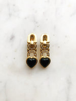 Travel back in time to the golden era of the 50s and 60s - but with a modern twist - with these vintage retro crystal love heart clip on earrings! Perfect for adding a unique and special sparkle to any outfit, these earrings are sure to make a statement! (And don't worry, no pierced ears required!)  Clip-on  Gold plated  42mm x 13mm