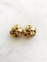 Indulge in the timeless elegance of our Vintage Ribbon Clip On Earrings. Featuring a delicate ribbon design, these earrings add a touch of sophistication to any outfit. With their convenient clip-on style, you can effortlessly add a touch of vintage glamour without the need for pierced ears. Perfect for the modern woman with a love for classic beauty. Clip On Earrings. Gold Plated. 20mm x 20mm.