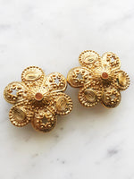 Add a touch of vintage glamour to your look with these playful Golden Stars & Spirals Enamel Clip on Earrings. With their retro design and easy clip-on feature, these earrings will instantly elevate any outfit. Perfect for those who love to make a statement with their style. Clip On Earrings. Gold Plated 40mm x 40mm