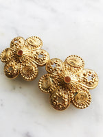 Add a touch of vintage glamour to your look with these playful Golden Stars & Spirals Enamel Clip on Earrings. With their retro design and easy clip-on feature, these earrings will instantly elevate any outfit. Perfect for those who love to make a statement with their style. Clip On Earrings. Gold Plated 40mm x 40mm