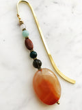 Handmade Bookmark using Semi Precious Crystals   Each bookmark is unique and carefully crafted to have a vintage feel and look. Crystals from top down Rose Quartz Amazonite Jasper Indian Agate Smokey Quartz Agate  13.5cm long