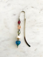 These bookmarks are handmade using vintage beads from broken or mismatched necklaces and earrings. Each bookmark is unique and carefully crafted to have a vintage feel and look. 12.5cm long