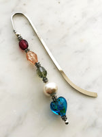 These bookmarks are handmade using vintage beads from broken or mismatched necklaces and earrings. Each bookmark is unique and carefully crafted to have a vintage feel and look. 12.5cm long