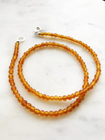 Bohemian Vintage Amber Glass Beaded Necklace Add some vintage charm to your look with this Bohemian Amber Glass Beaded Necklace. Featuring unique amber glass beads, this necklace will add a touch of whimsy to any outfit. Perfect for the free spirit who loves a touch of quirkiness in their fashion. Vintage glass beads 45cm