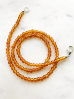 Bohemian Vintage Amber Glass Beaded Necklace Add some vintage charm to your look with this Bohemian Amber Glass Beaded Necklace. Featuring unique amber glass beads, this necklace will add a touch of whimsy to any outfit. Perfect for the free spirit who loves a touch of quirkiness in their fashion. Vintage glass beads 45cm