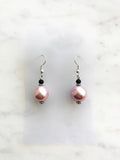 Spice up your earring collection with these quirky handmade Vintage Pink Glass Pearl and black glass bead earrings. Channel retro vibes and unleash your playful side while rocking these unique and stylish accessories. Perfect for adding a touch of fun to any outfit.  Handmade using vintage pink glass pearls and black glass beads.  45mm x 13mm  Nickle free ear hooks for sensitive ears.