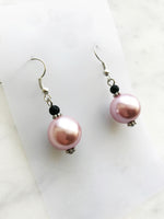 Spice up your earring collection with these quirky handmade Vintage Pink Glass Pearl and black glass bead earrings. Channel retro vibes and unleash your playful side while rocking these unique and stylish accessories. Perfect for adding a touch of fun to any outfit.  Handmade using vintage pink glass pearls and black glass beads.  45mm x 13mm  Nickle free ear hooks for sensitive ears