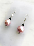 Spice up your earring collection with these quirky handmade Vintage Pink Glass Pearl and black glass bead earrings. Channel retro vibes and unleash your playful side while rocking these unique and stylish accessories. Perfect for adding a touch of fun to any outfit.  Handmade using vintage pink glass pearls and black glass beads.  45mm x 13mm  Nickle free ear hooks for sensitive ears