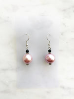 Spice up your earring collection with these quirky handmade Vintage Pink Glass Pearl and black glass bead earrings. Channel retro vibes and unleash your playful side while rocking these unique and stylish accessories. Perfect for adding a touch of fun to any outfit.  Handmade using vintage pink glass pearls and black glass beads.  45mm x 13mm  Nickle free ear hooks for sensitive ears