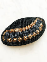 Add some vintage charm to your hair with this hand-crafted seed bead barrette. Made in France, it's a unique and stylish accessory that will elevate any hairstyle. Perfect for adding a touch of playfulness to your look!  Made by hand in France  113mm x 58mm