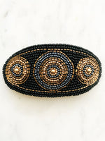 Add some vintage charm to your hair with this hand-crafted seed bead barrette. Made in France, it's a unique and stylish accessory that will elevate any hairstyle. Perfect for adding a touch of playfulness to your look!  Made by hand in France  113mm x 58mm