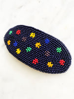 Add a touch of retro beauty to your hair with this Vintage Seed Bead Flower Barrette. The colorful, delicate beads create a charming flower design, making this barrette a unique and playful addition to any hairstyle. So go ahead, channel your inner flower child with this vintage-inspired hair accessory.  Made by hand  97mm x 45mm