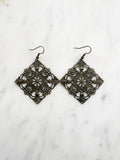 Large Antique Bronze Vintage Filigree Square Earrings
Add a touch of whimsy with these Vintage Filigree Earrings. These lightweight beauties feature intricate filigree designs for a boho vibe. Perfect for a playful and carefree look.
Lightweight brass metal stampings with an antique bronze patina.
65mm from the top of the ear hook x 49mm