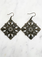 Large Antique Bronze Vintage Filigree Square Earrings
Add a touch of whimsy with these Vintage Filigree Earrings. These lightweight beauties feature intricate filigree designs for a boho vibe. Perfect for a playful and carefree look.
Lightweight brass metal stampings with an antique bronze patina.
65mm from the top of the ear hook x 49mm