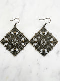 Large Antique Bronze Vintage Filigree Square Earrings
Add a touch of whimsy with these Vintage Filigree Earrings. These lightweight beauties feature intricate filigree designs for a boho vibe. Perfect for a playful and carefree look.
Lightweight brass metal stampings with an antique bronze patina.
65mm from the top of the ear hook x 49mm