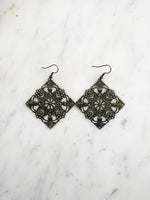 Large Antique Bronze Vintage Filigree Square Earrings
Add a touch of whimsy with these Vintage Filigree Earrings. These lightweight beauties feature intricate filigree designs for a boho vibe. Perfect for a playful and carefree look.
Lightweight brass metal stampings with an antique bronze patina.
65mm from the top of the ear hook x 49mm