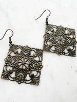 Large Antique Bronze Vintage Filigree Square Earrings
Add a touch of whimsy with these Vintage Filigree Earrings. These lightweight beauties feature intricate filigree designs for a boho vibe. Perfect for a playful and carefree look.
Lightweight brass metal stampings with an antique bronze patina.
65mm from the top of the ear hook x 49mm