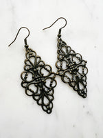 Antique Bronze Vintage Filigree Earrings. Add a touch of whimsy with our Vintage Filigree Earrings. These lightweight beauties feature intricate filigree designs for a boho vibe. Perfect for a playful and carefree look.
Lightweight brass metal stampings with an antique bronze patina.
72mm from the top of the ear hook x 30mm