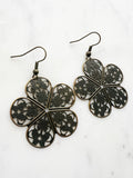 Antique Bronze Vintage Filigree Boho Flower Earrings
Add a touch of whimsy with our Vintage Filigree Earrings. These lightweight beauties feature intricate filigree designs for a boho vibe. Perfect for a playful and carefree look.
Lightweight brass metal stampings with an antique bronze patina.
53mm from the top of the ear hook x 33mm