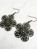 Antique Bronze Vintage Filigree Boho Flower Earrings
Add a touch of whimsy with our Vintage Filigree Earrings. These lightweight beauties feature intricate filigree designs for a boho vibe. Perfect for a playful and carefree look.
Lightweight brass metal stampings with an antique bronze patina.
53mm from the top of the ear hook x 33mm