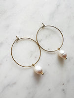 Elevate your style with these elegant Natural White Freshwater Rice Pearl Hoops. Featuring 8-9mm luminous natural white freshwater pearls delicately paired with 30mm hoops crafted from high-grade 304 Surgical Stainless Steel. Vacuum plated in Rhodium, these hoops offer a bright, durable finish and are perfect for sensitive skin. Timeless sophistication meets everyday wearability!