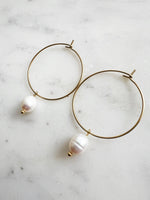 Elevate your style with these elegant Natural White Freshwater Rice Pearl Hoops. Featuring 8-9mm luminous natural white freshwater pearls delicately paired with 30mm hoops crafted from high-grade 304 Surgical Stainless Steel. Vacuum plated in Rhodium, these hoops offer a bright, durable finish and are perfect for sensitive skin. Timeless sophistication meets everyday wearability!