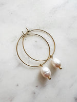 Elevate your style with these elegant Natural White Freshwater Rice Pearl Hoops. Featuring 8-9mm luminous natural white freshwater pearls delicately paired with 30mm hoops crafted from high-grade 304 Surgical Stainless Steel. Vacuum plated in Rhodium, these hoops offer a bright, durable finish and are perfect for sensitive skin. Timeless sophistication meets everyday wearability!